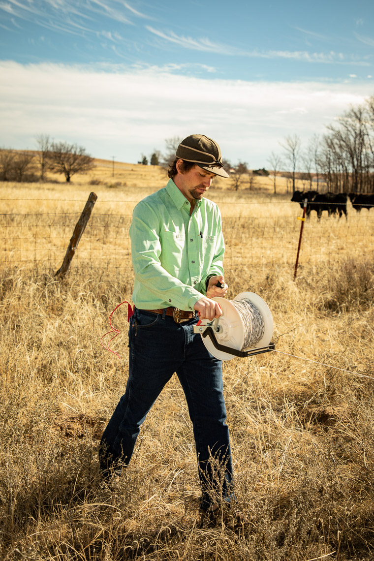 Adam Isaacs roles out  polywire for a temporary paddock at his Needmore Creek Ranch. Shot on location in Canadian, Texas for The New York Times. Brett Deering Photography