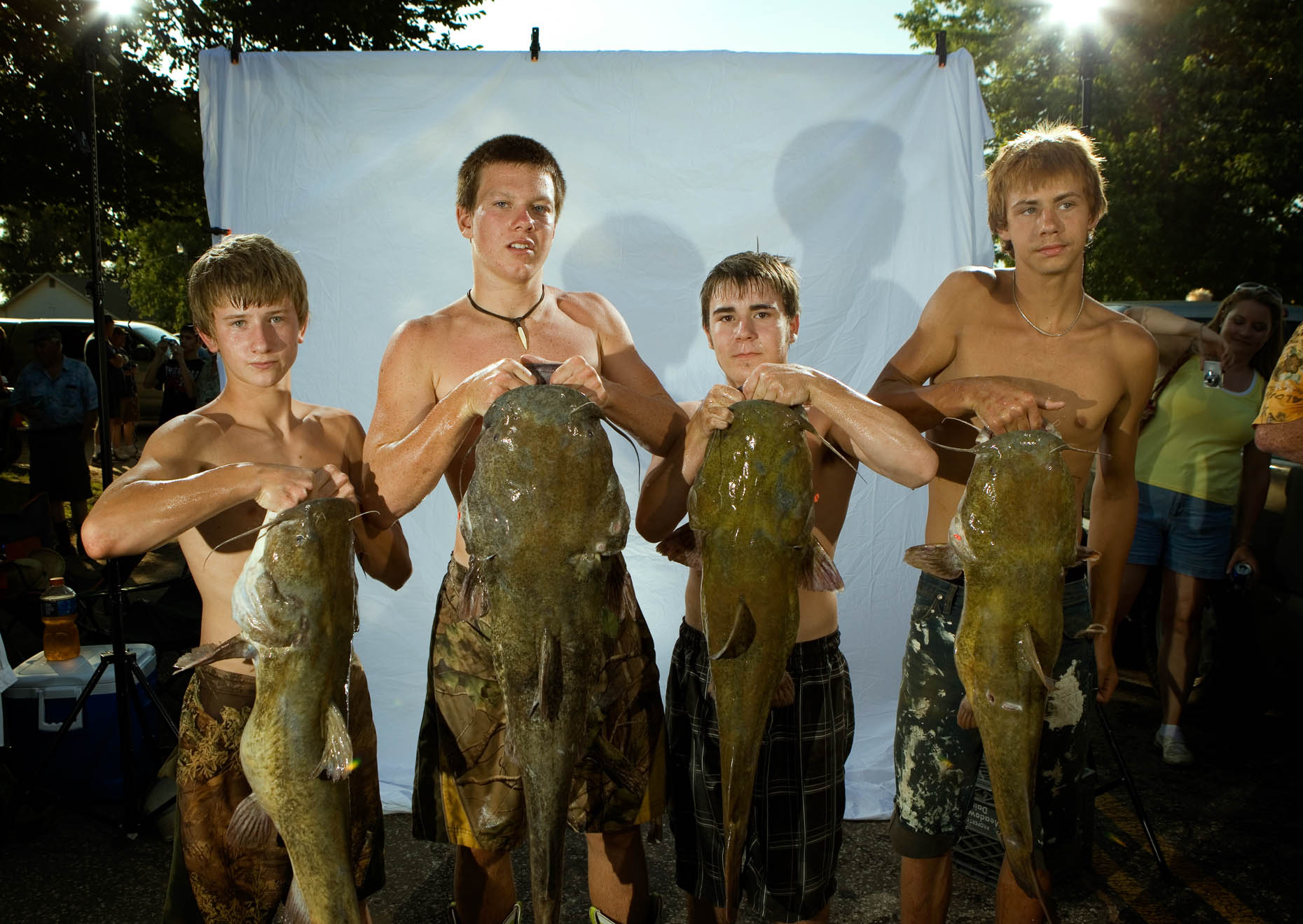 Young noodlers with their catfish at the Okie Noodling Tournament. 