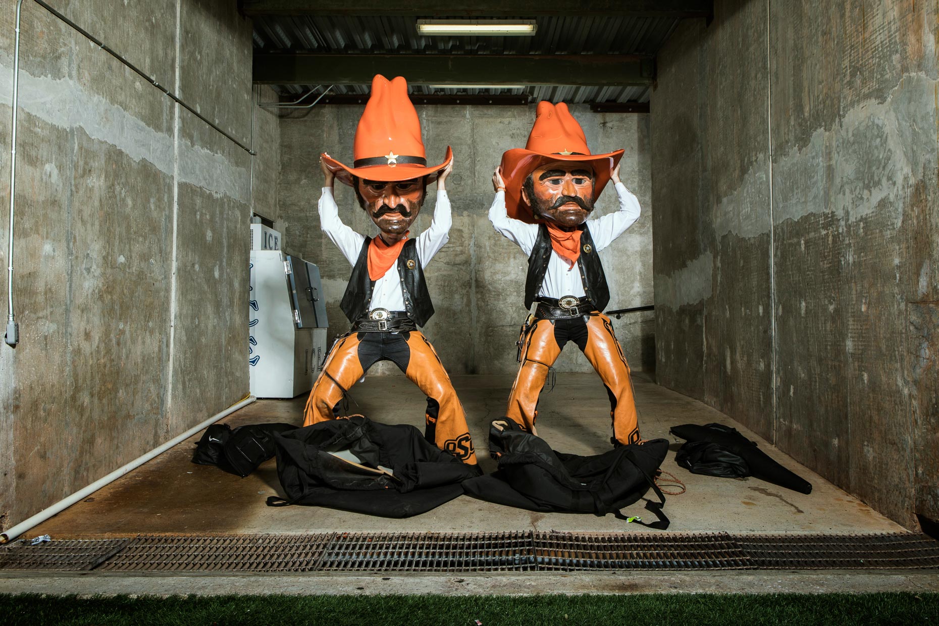 Austin Johnson, left, and Taylor Collins get dressed as Oklahoma State Cowboy